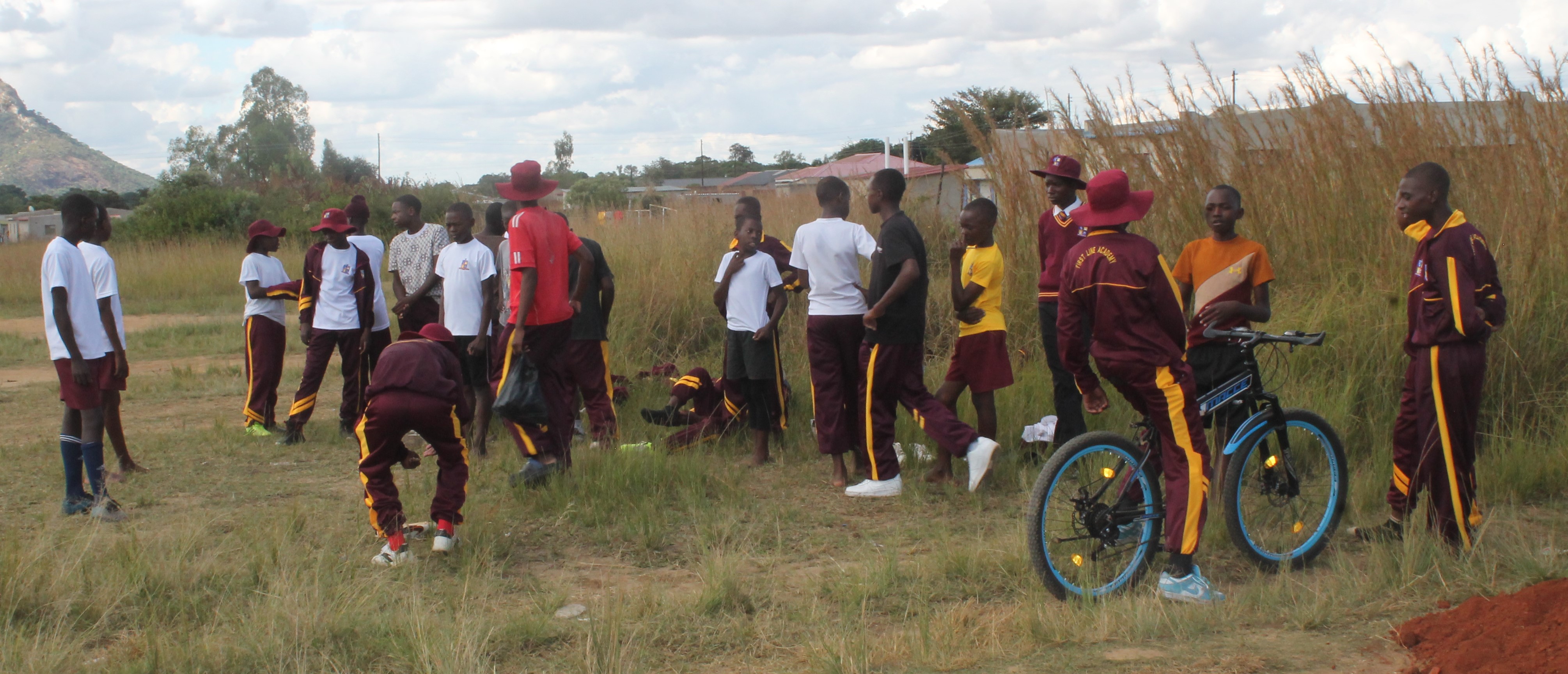 Students running athletic sports on the pitch